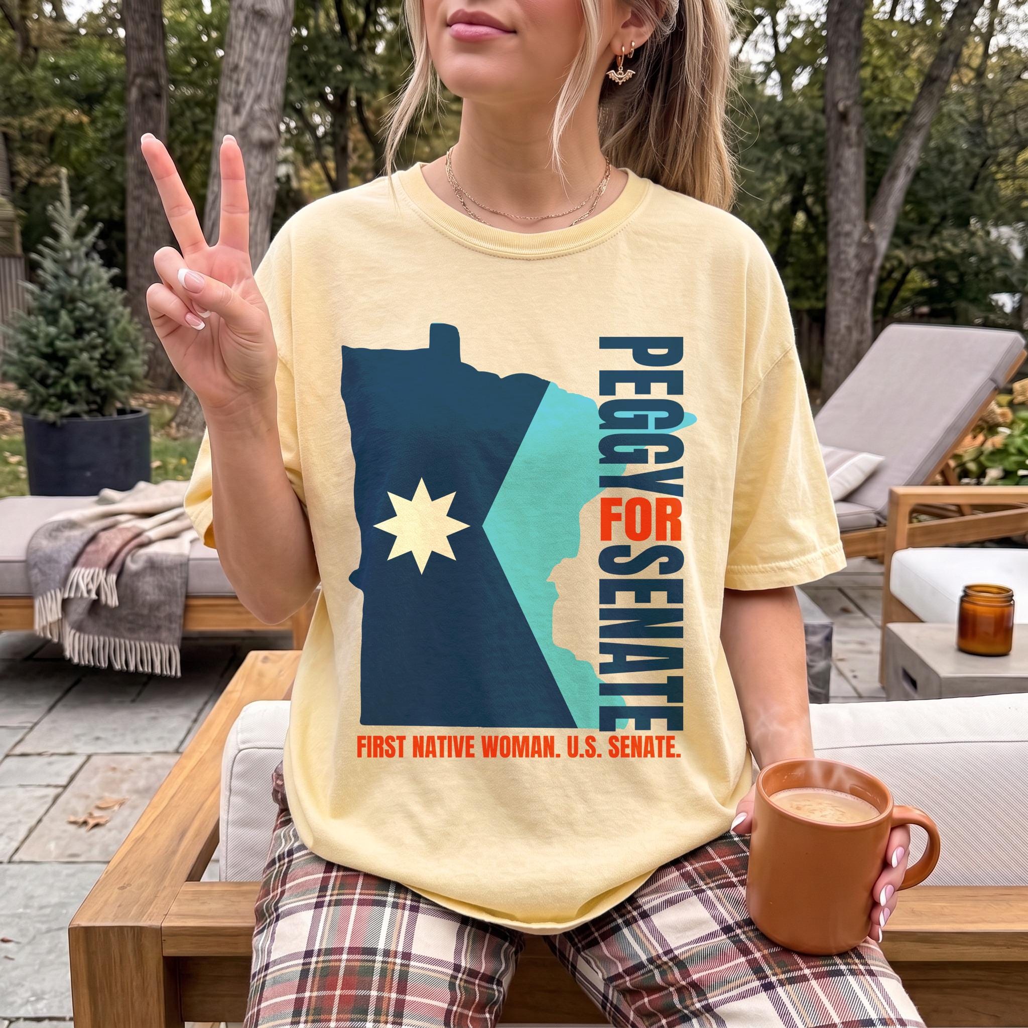 Yellow t-shirt with Minnesota shape graphic and "Peggy for Senate" text.