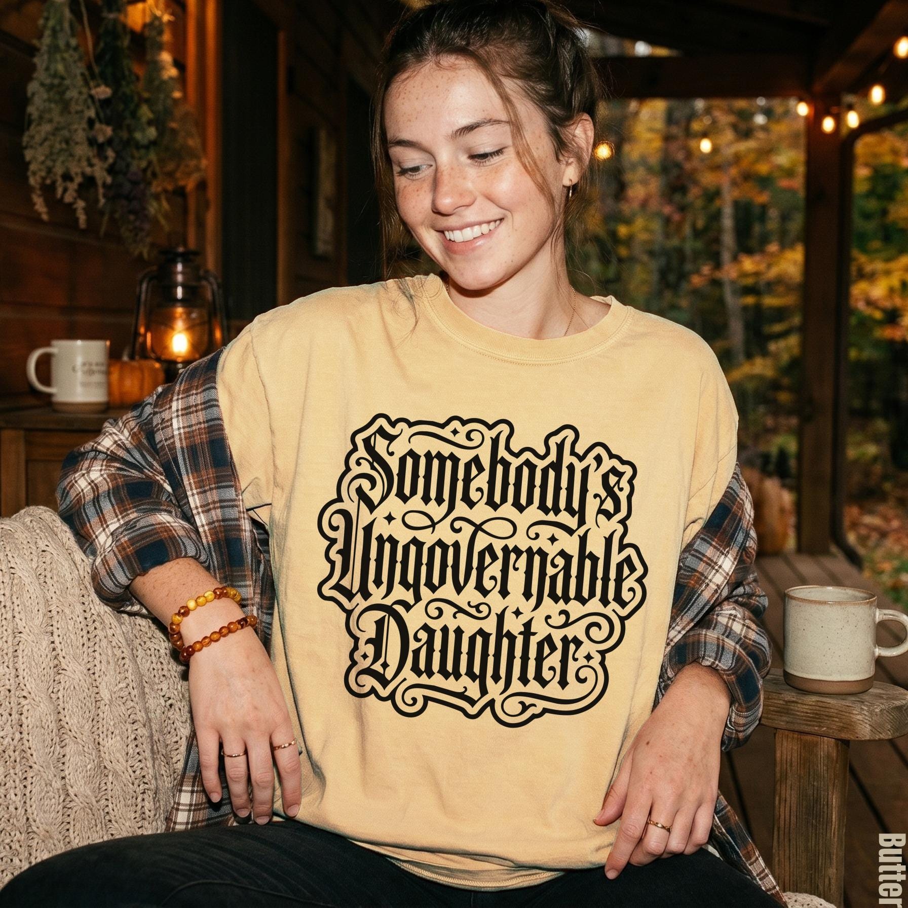 Woman wearing a yellow t-shirt with "Somebody&