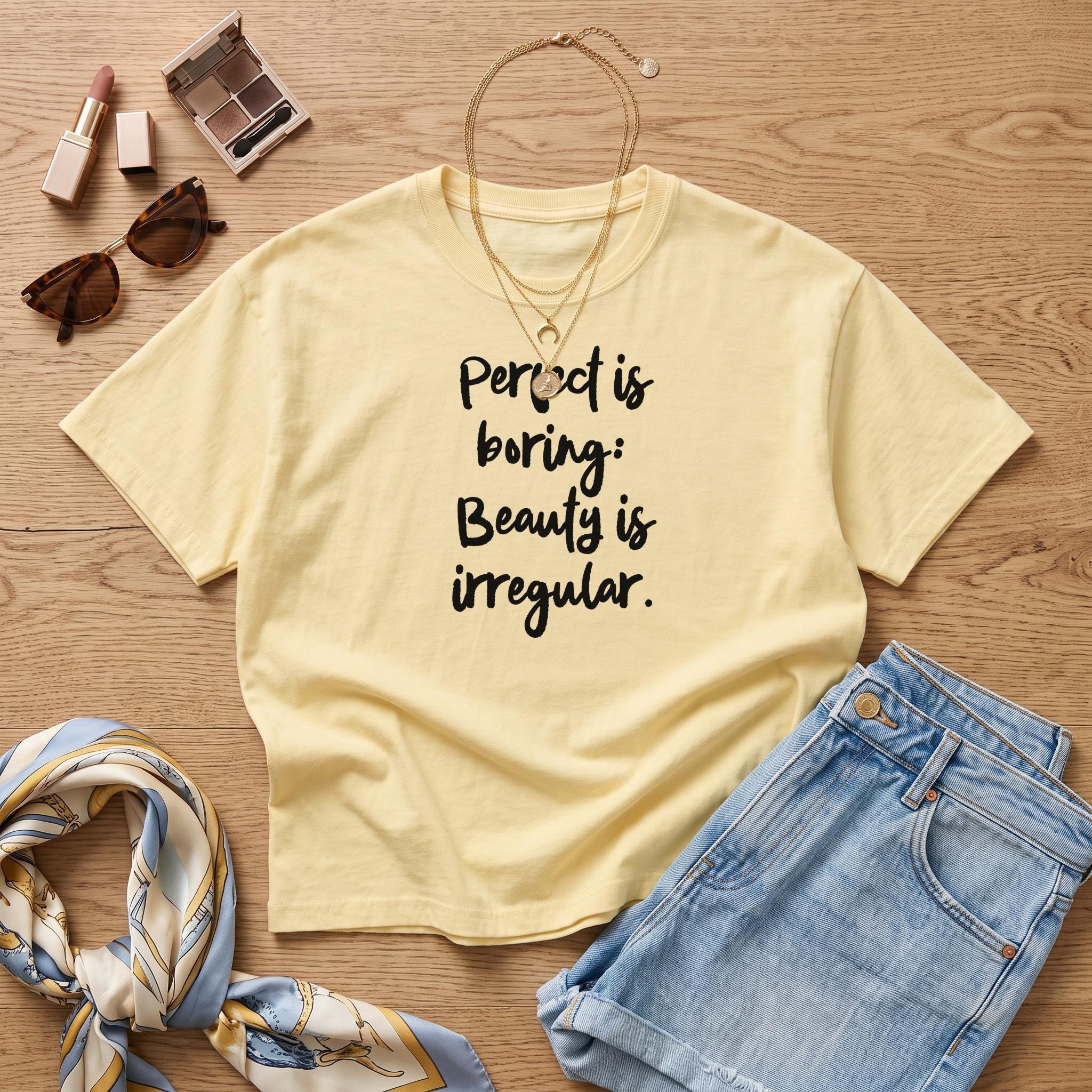 Yellow t-shirt with text "Perfect is boring: Beauty is irregular."