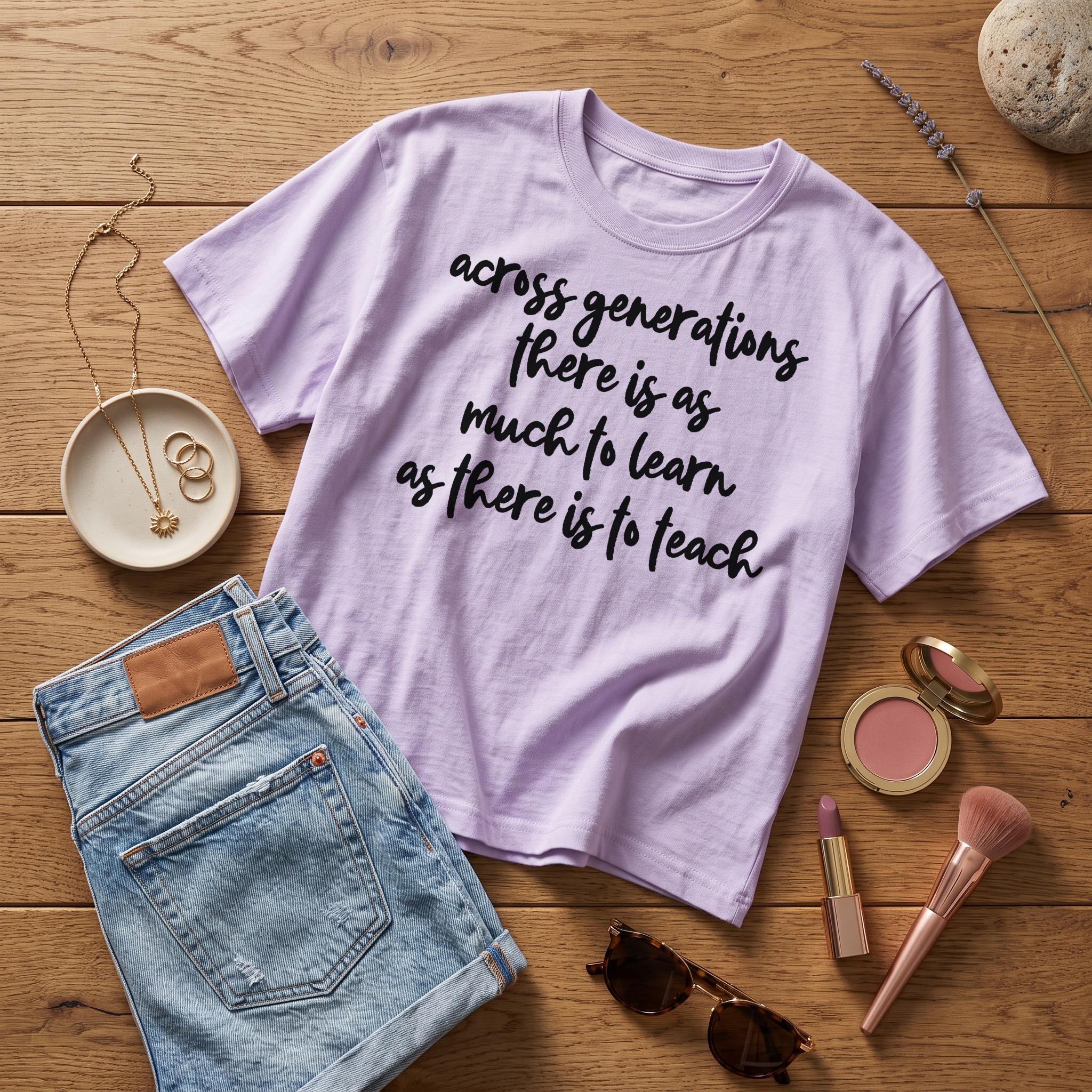 Lavender t-shirt with black text "across generations there is as much to learn as there is to teach."