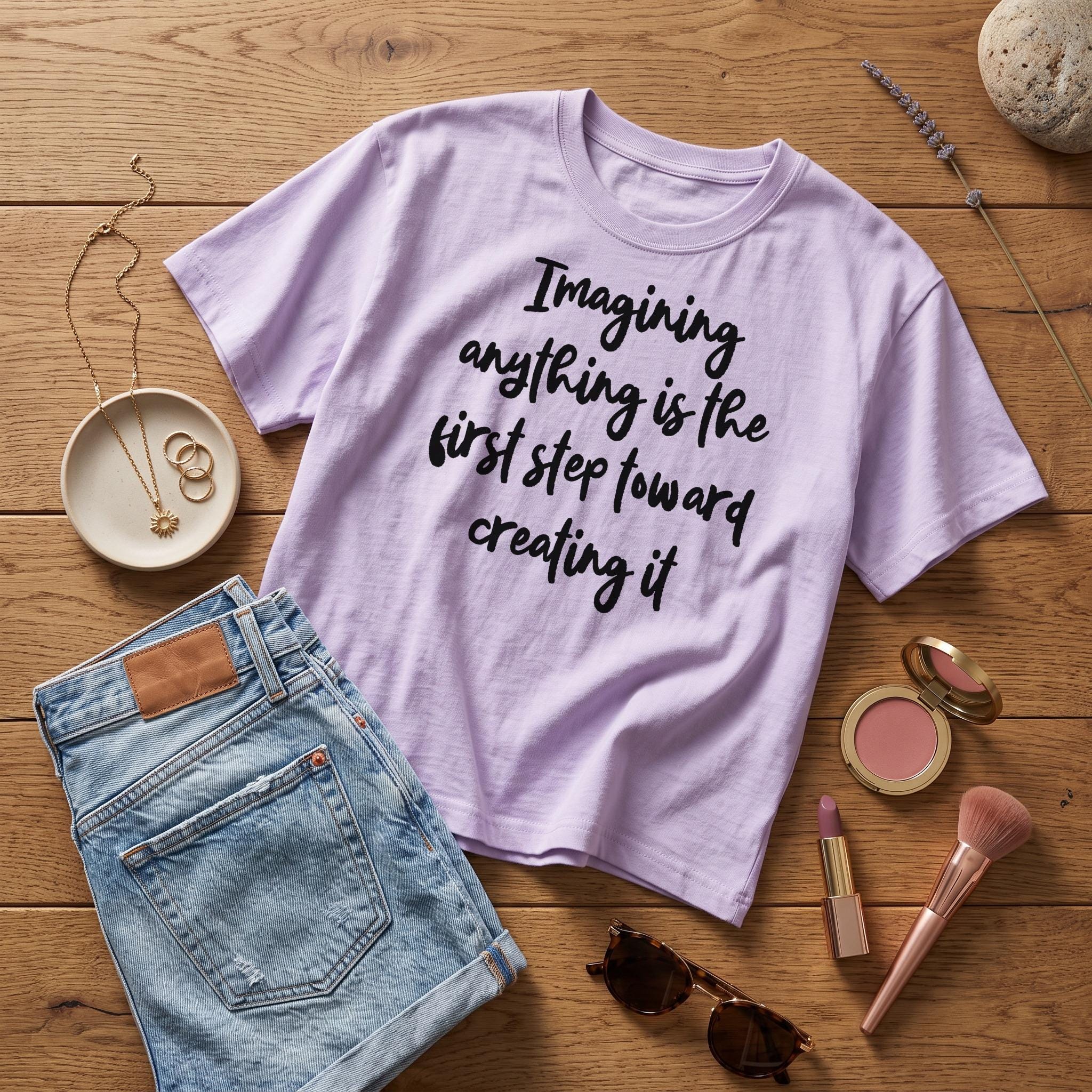 Lavender t-shirt with text "Imagining anything is the first step toward creating it".