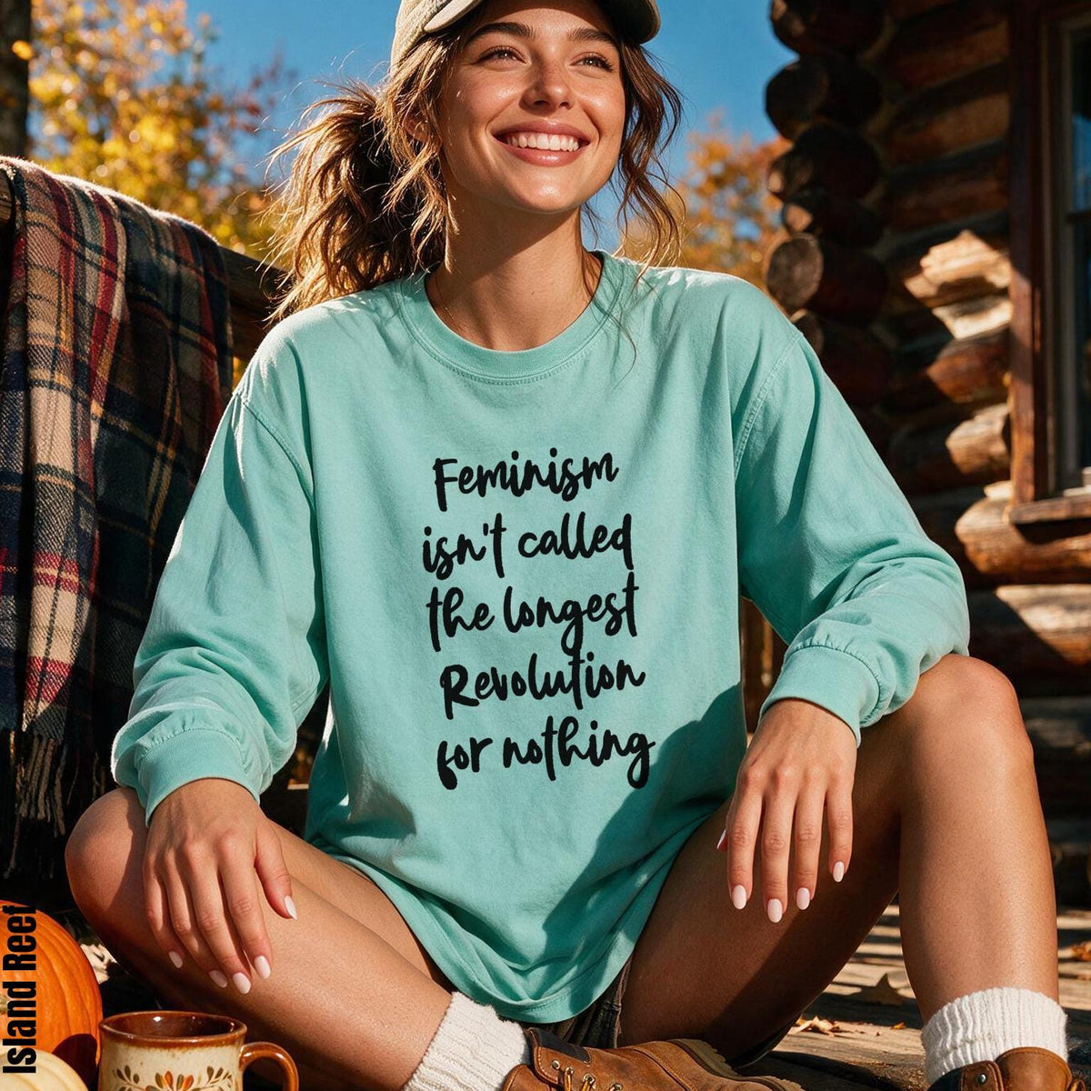 Mint green long-sleeve shirt with "Feminism isn&