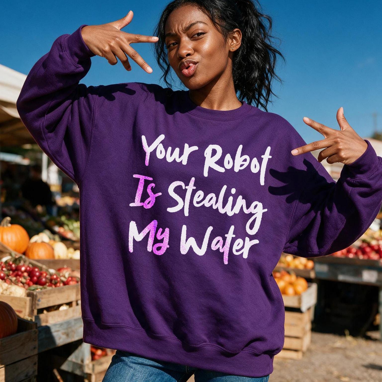 Woman in purple sweatshirt with text "Your Robot Is Stealing My Water".