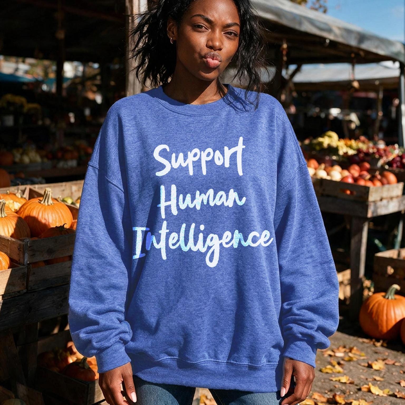 Blue sweatshirt with "Support Human Intelligence" text on a woman in an outdoor market.
