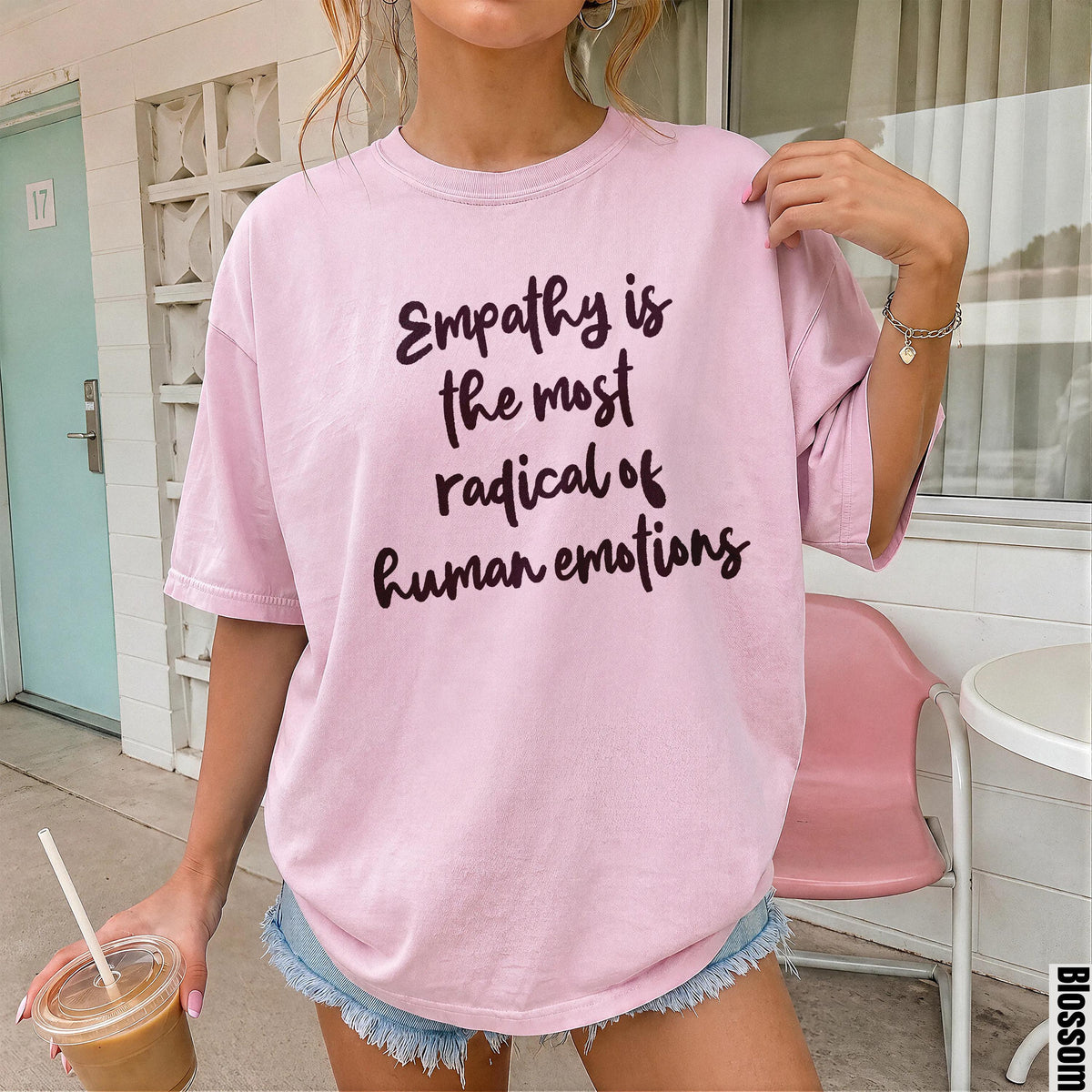 Pink t-shirt with "Empathy is the most radical of human emotions" text.