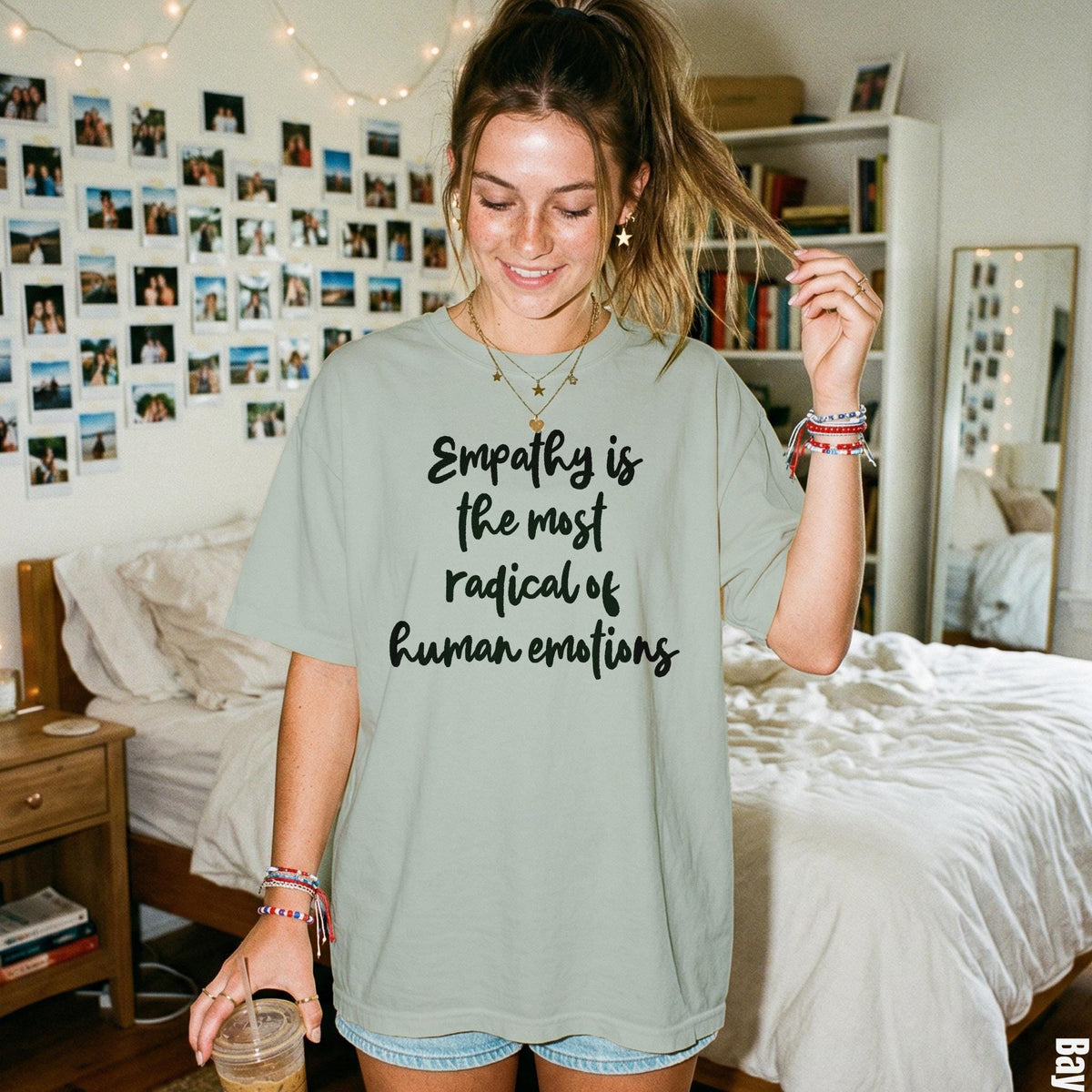 Light green t-shirt with black text "Empathy is the most radical of human emotions".