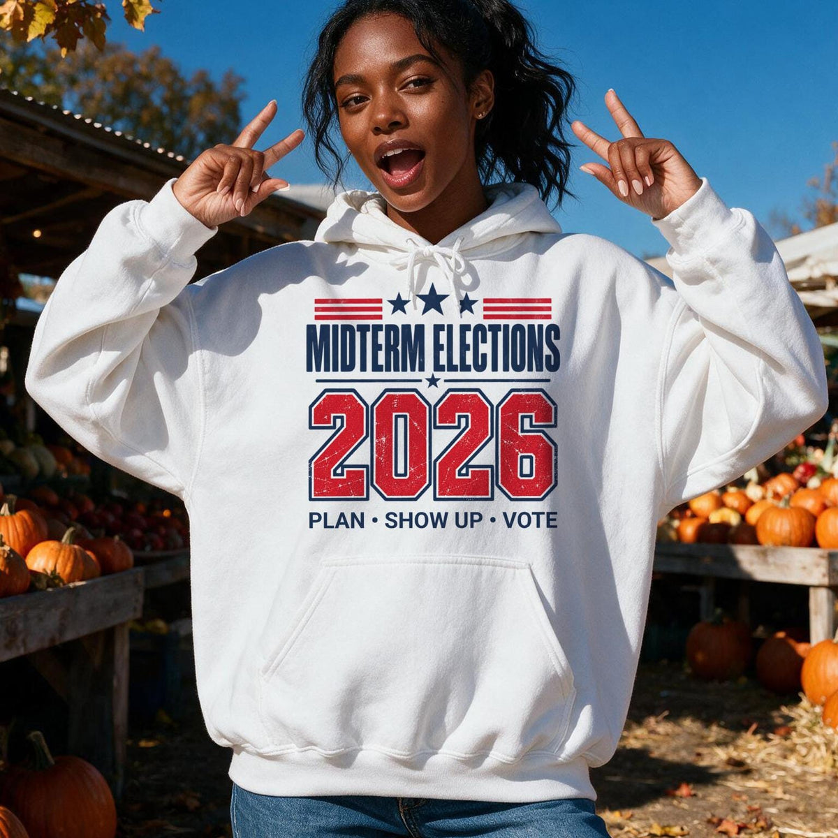 White hoodie with "Midterm Elections 2026 Plan Show Up Vote" text and patriotic graphics.