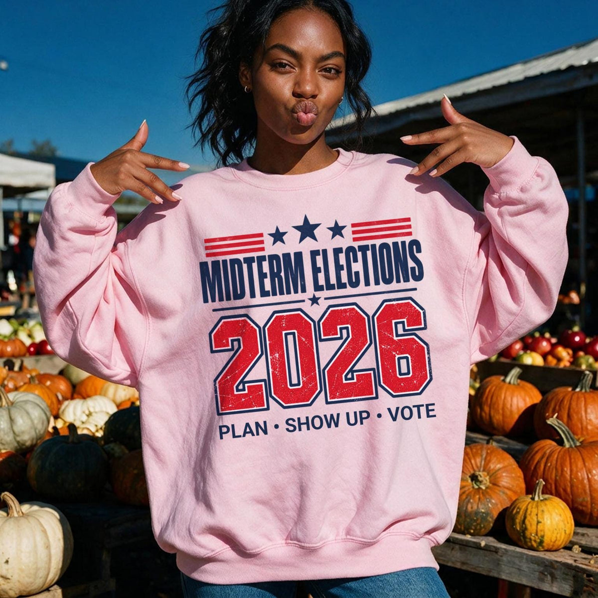 Pink sweatshirt with "Midterm Elections 2026 Plan Show Up Vote" text.