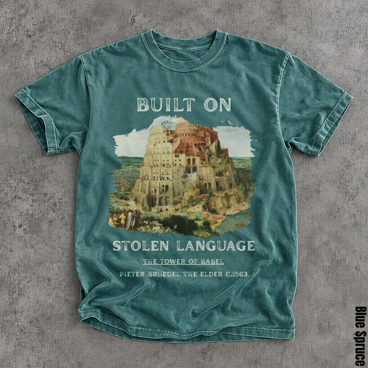 Blue t-shirt with "Built on Stolen Language" and The Tower of Babel art.