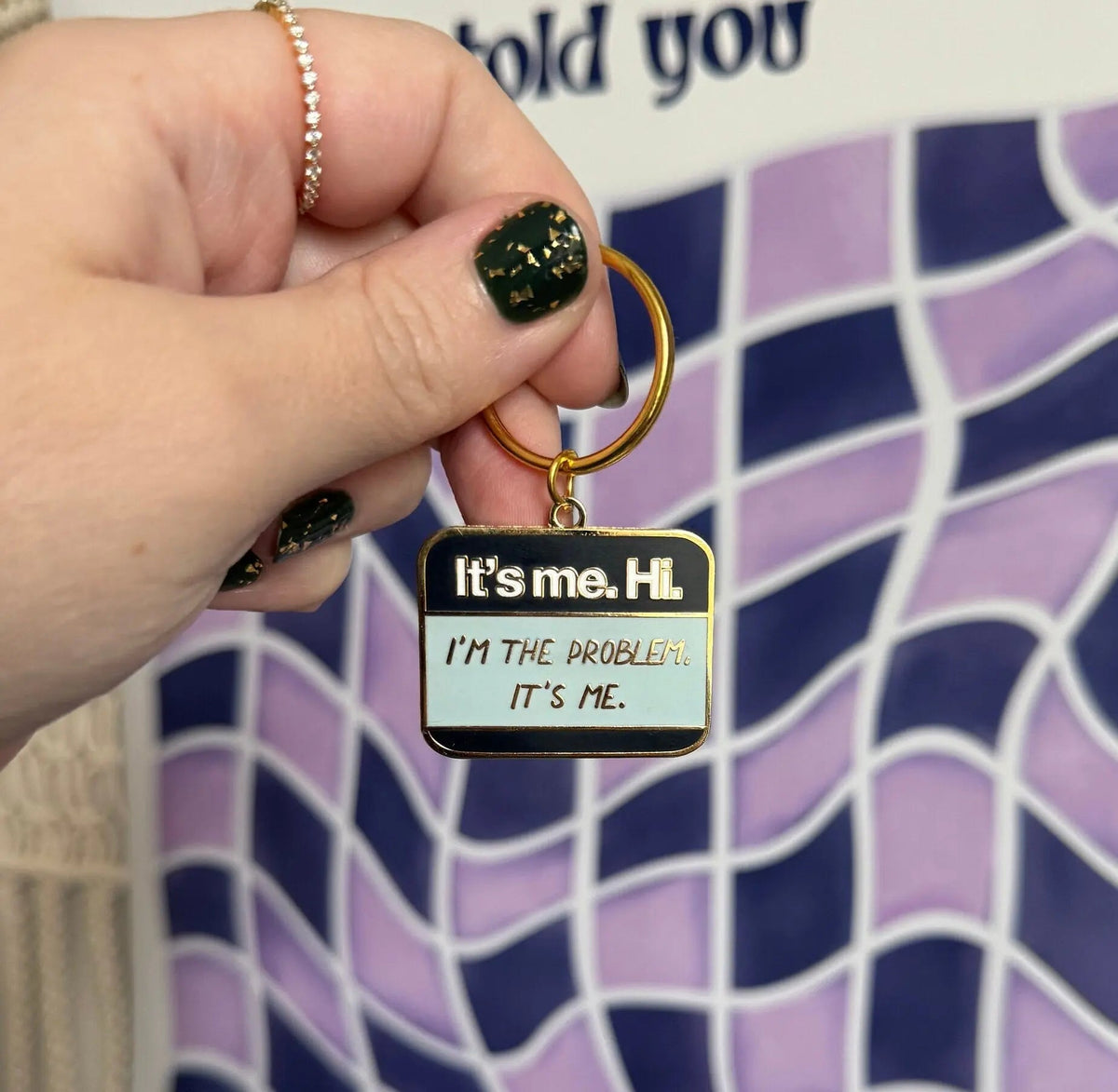 It’s me Hi I’m the problem It’s me enamel keychain scale view — 1.5 by 1 inch enamel bag charm by indie artist MangoIllustrated