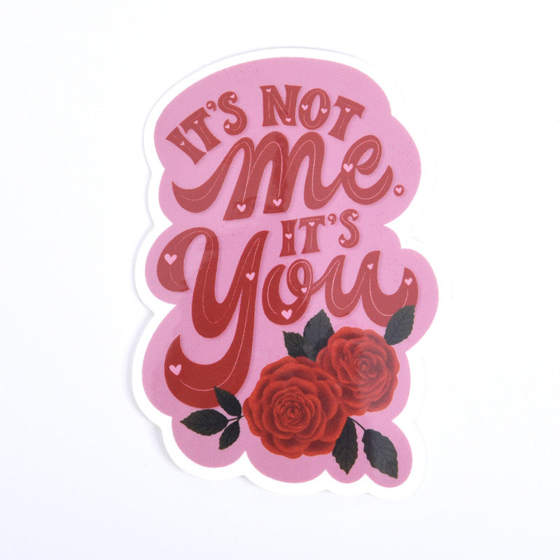 A pink sticker with the text &
