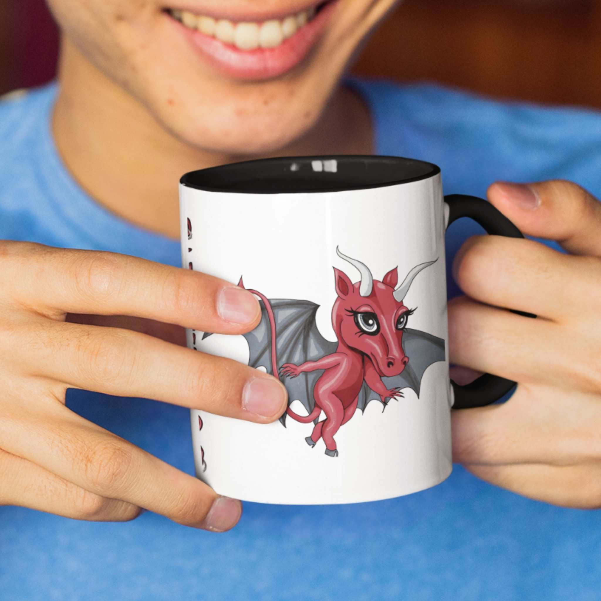 Person in a blue shirt smiling and holding the cute Jersey Devil cryptid mug