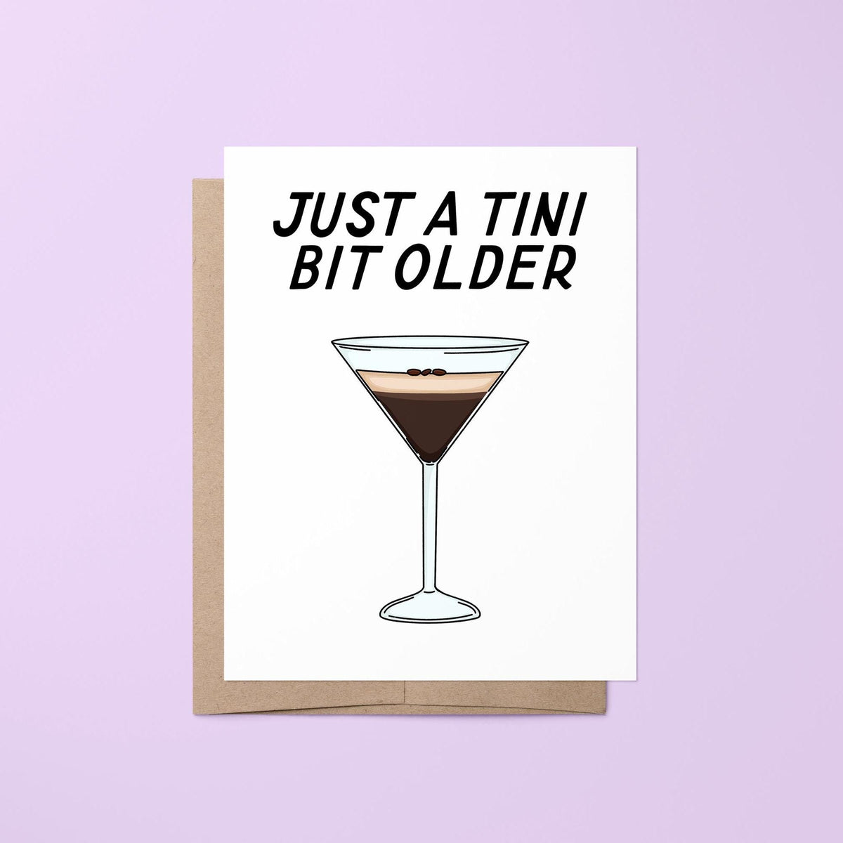 Just a tini bit older card — hand lettered martini pun birthday greeting with a hand drawn espresso martini, folded 4.25 x 5.5 in A2, by MangoIllustrated