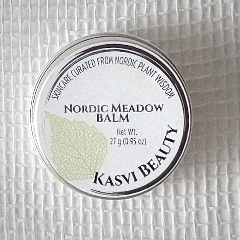A round metal tin of Kasvi Beauty Nordic Meadow Balm, featuring a white label with a light green birch leaf graphic and black text, set against a white textured background.