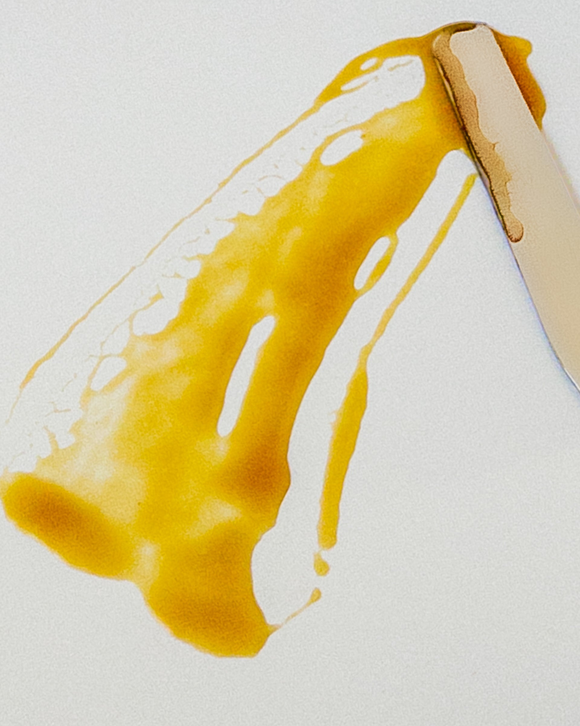 Kasvi Beauty Twilight Birch Nighttime Serum brownish yellow gel-serum being spread with a spatula on a white background