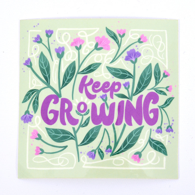 A sticker with a floral design and the text &
