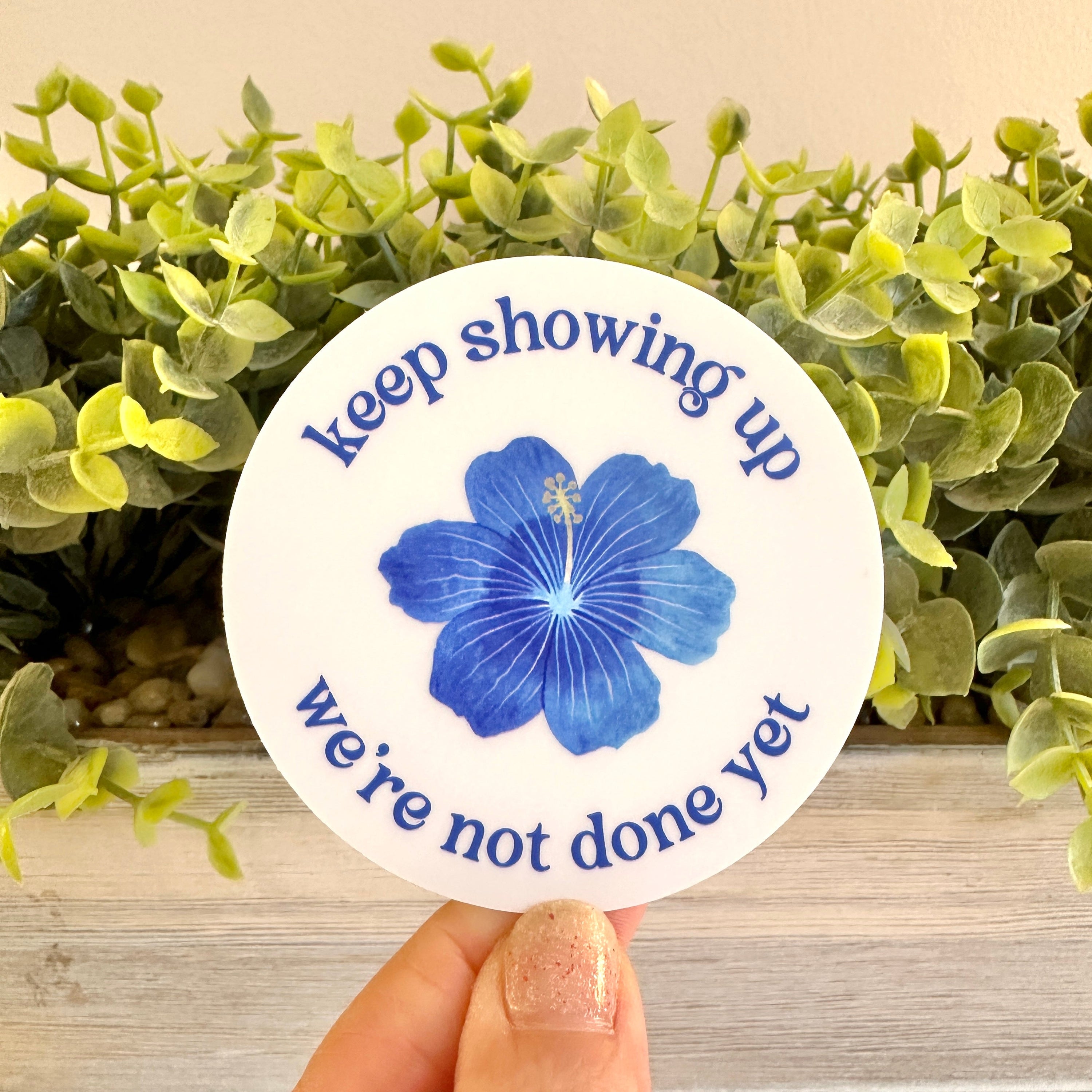 Circular sticker with blue flower and text &