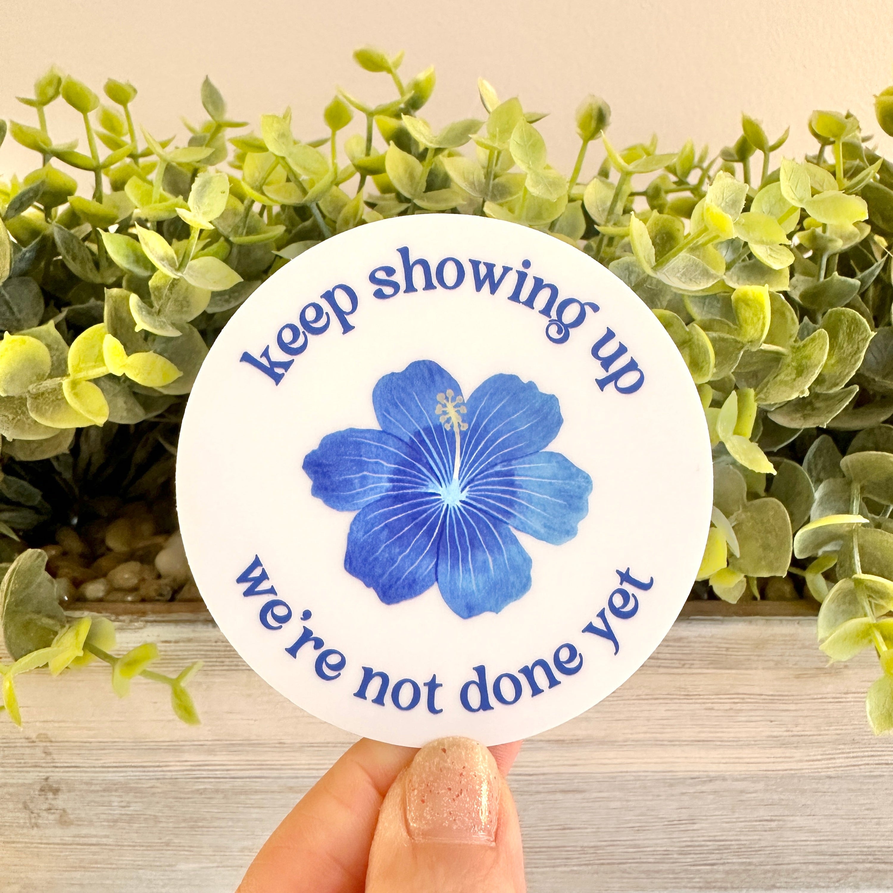 Circular sticker with blue flower and text &