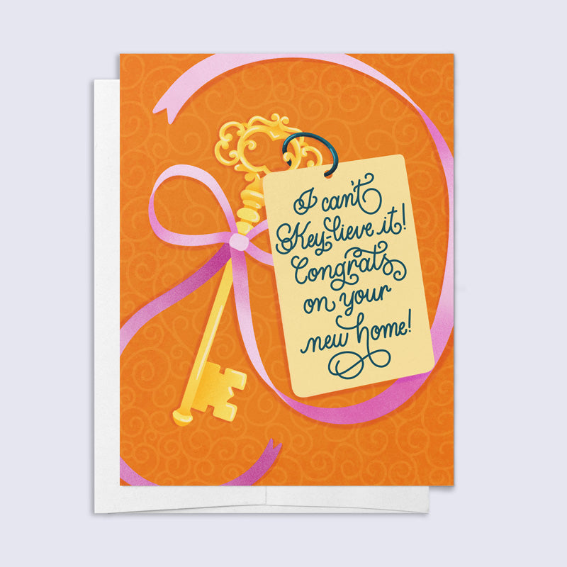 Greeting card with a gold key and pink ribbon on an orange background, featuring text &