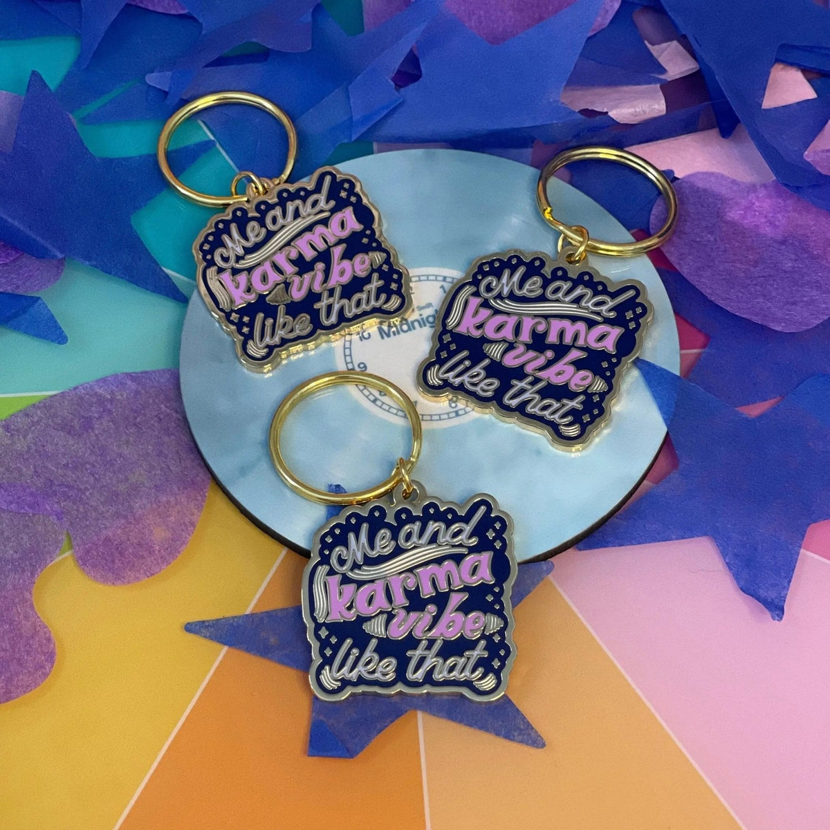 Me and Karma Vibe Like That enamel keychain styled shot — colorful hand lettered keychain for keys and backpacks by indie artist MangoIllustrated