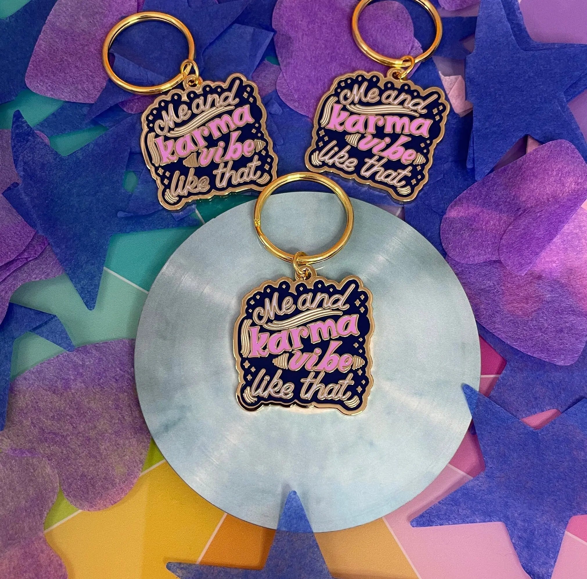 Me and Karma Vibe Like That enamel keychain flat lay — hard enamel keyring on a split ring by indie artist MangoIllustrated