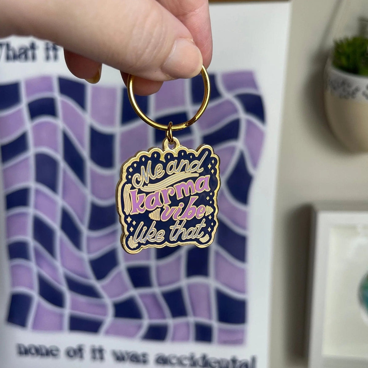 Me and Karma Vibe Like That enamel keychain detail — close up of the gold hand lettering by indie artist MangoIllustrated