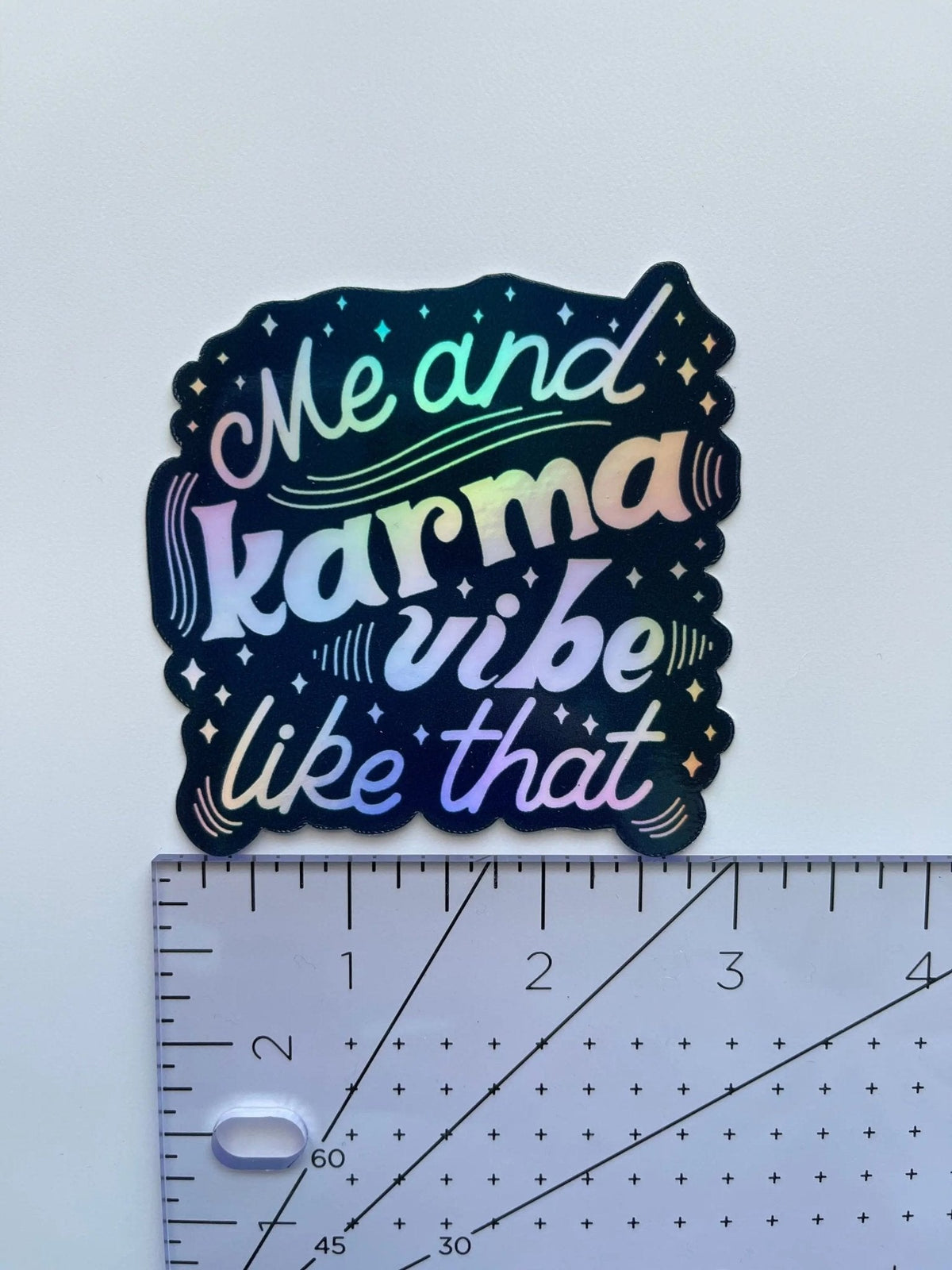 Me and Karma Vibe Like That holographic sticker flat lay — holographic laptop sticker in navy ink by indie artist MangoIllustrated