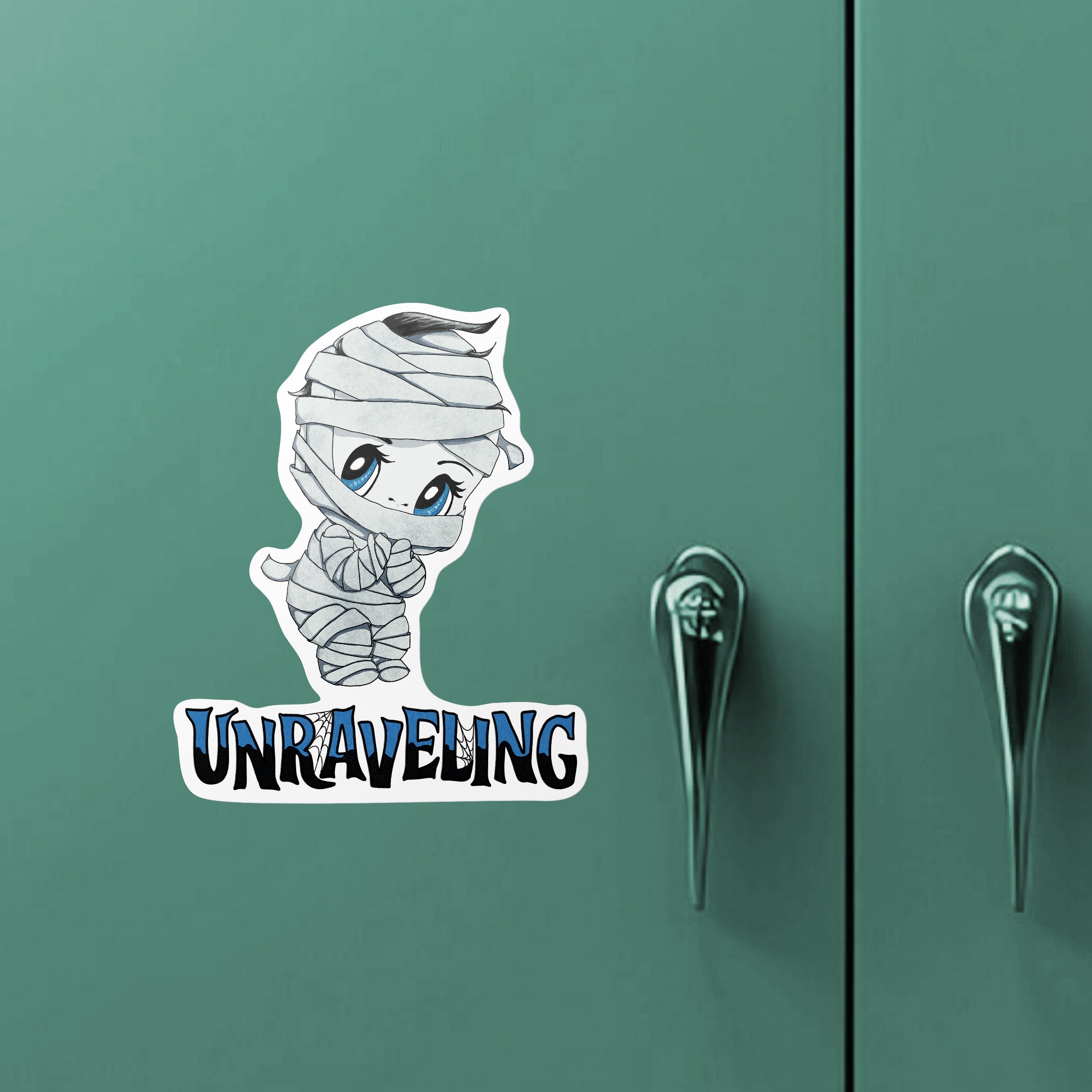 Chibi mummy monster sticker on a green metal locker door