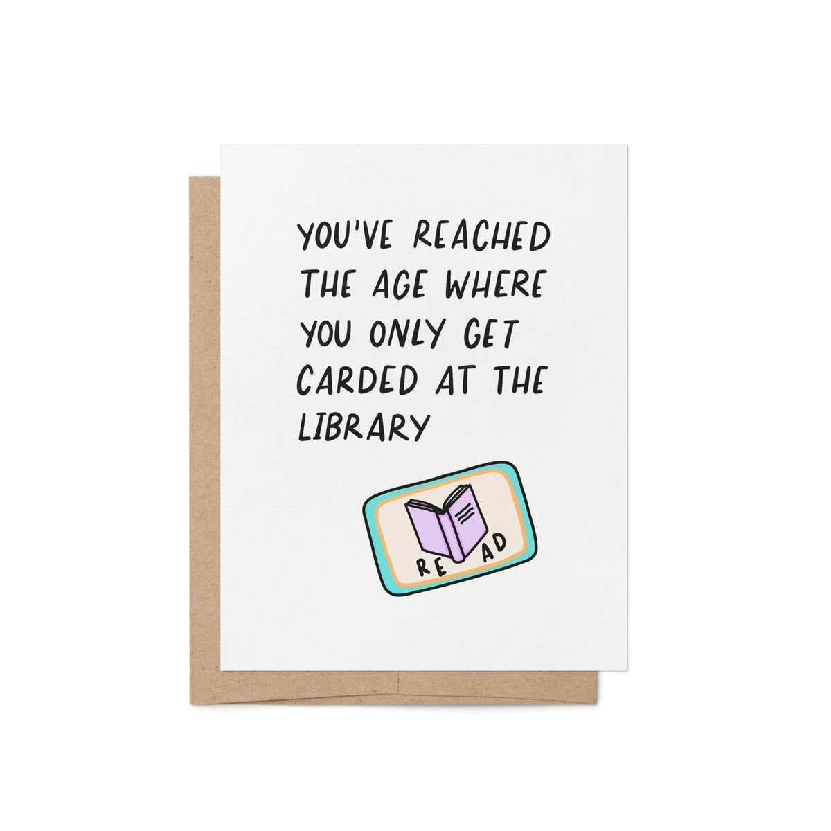 Only Get Carded at the Library Birthday Card flat lay — funny book lover birthday card styled on a desk by indie artist MangoIllustrated
