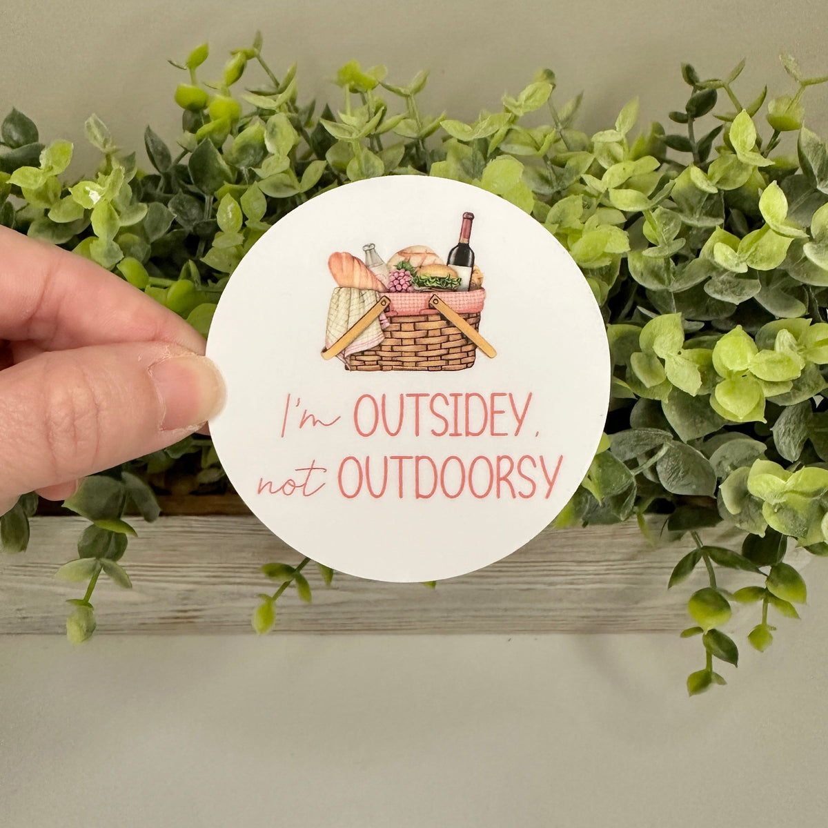 hand holding sticker with text "I&