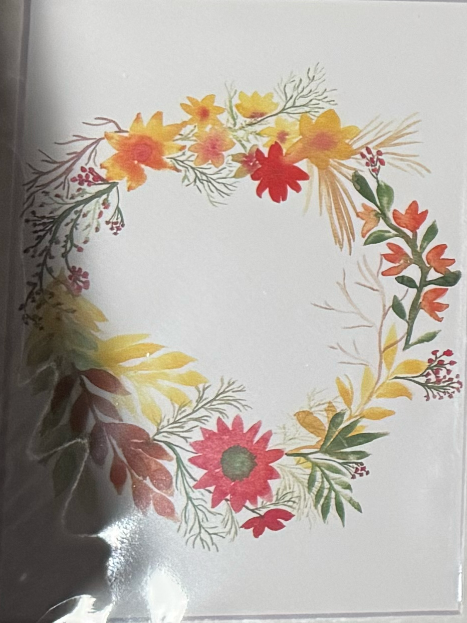 Floral wreath design on a white card.