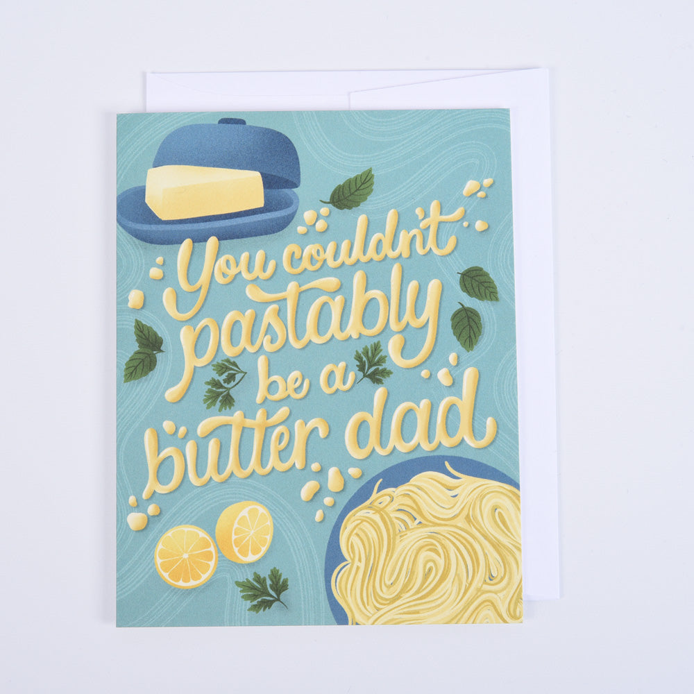 A folded greeting card with a colorful illustration, featuring a dish of butter and a pasta dish, with a quote &