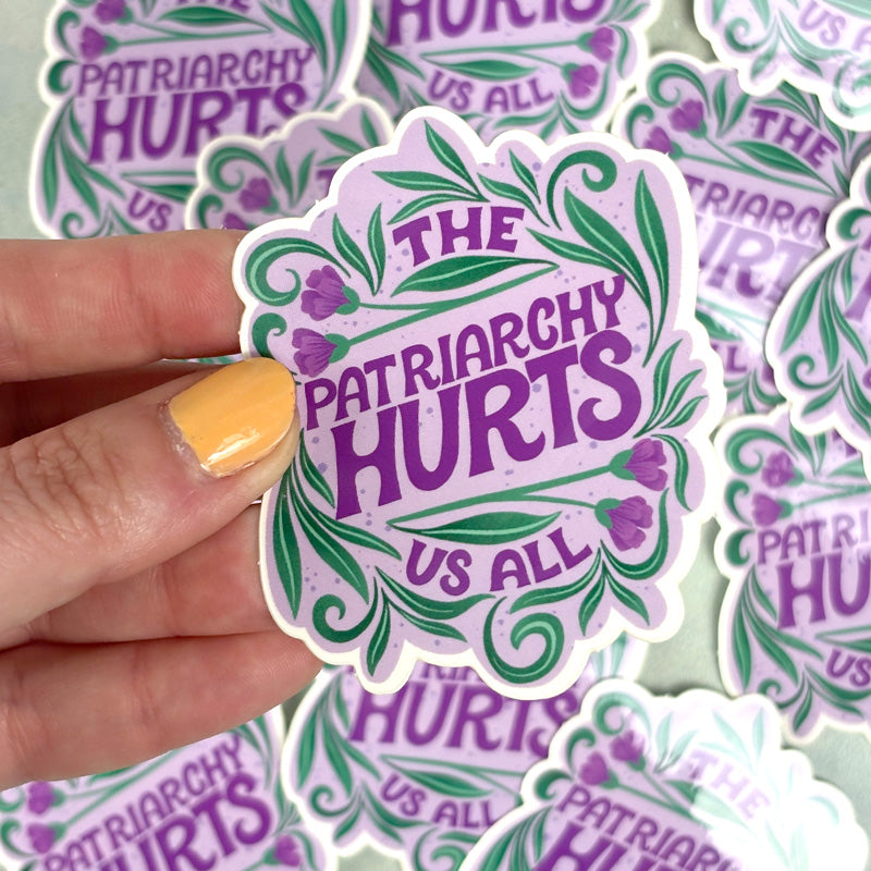 A sticker with a purple background and the text &