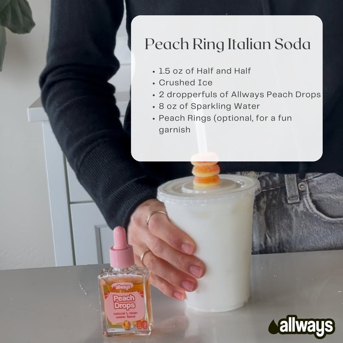 Person holding a Peach Ring Italian Soda with a recipe card and Allways Peach Drops bottle on a table.