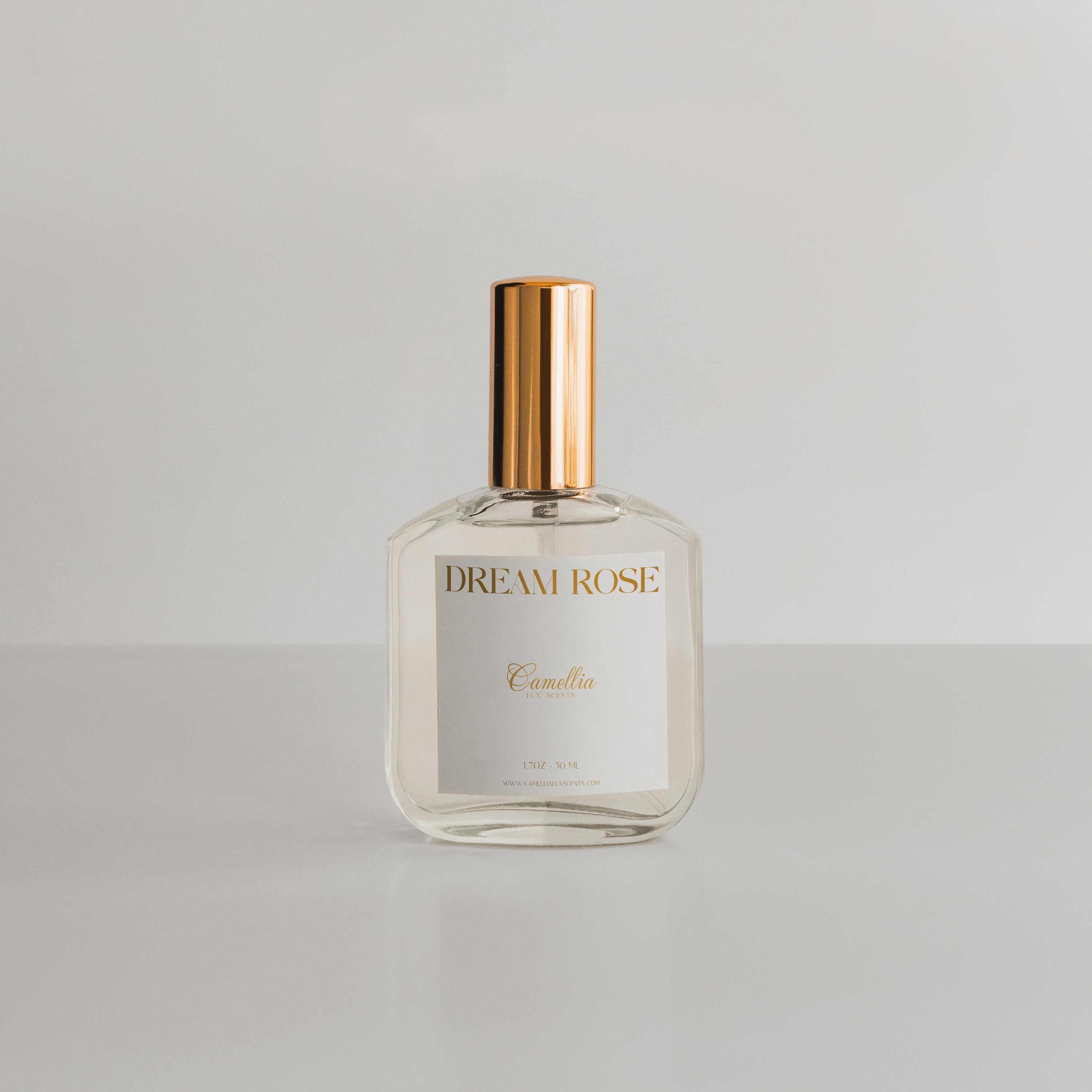 Dream Rose Perfume by Camellia Lux Scents - 1.7oz clear glass spray bottle with rose gold cap, a romantic floral fragrance with notes of Turkish rose, black currant, and iris