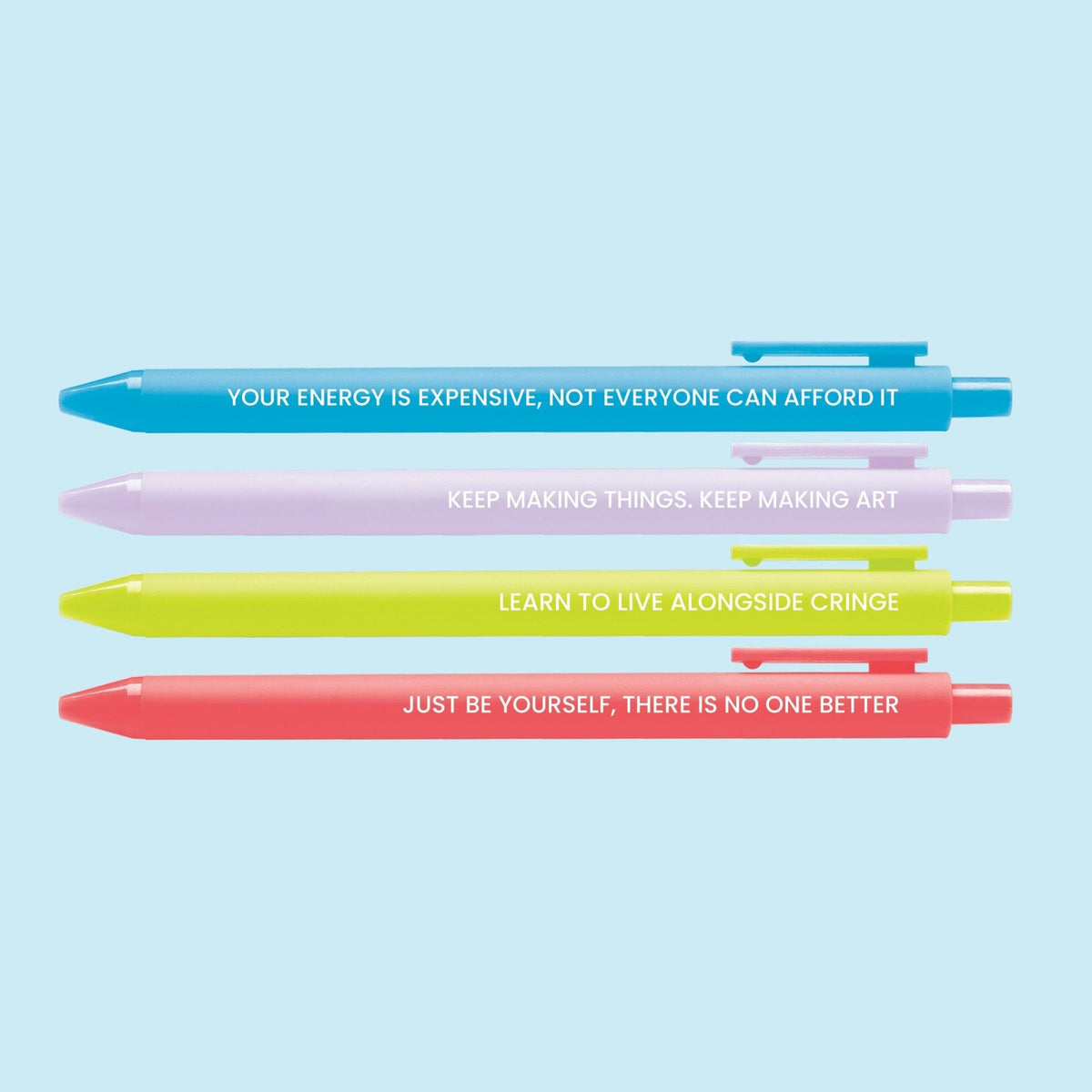Swift Affirmations pen set detail — Learn to live alongside cringe and Just be yourself pens in white lettering by indie artist MangoIllustrated
