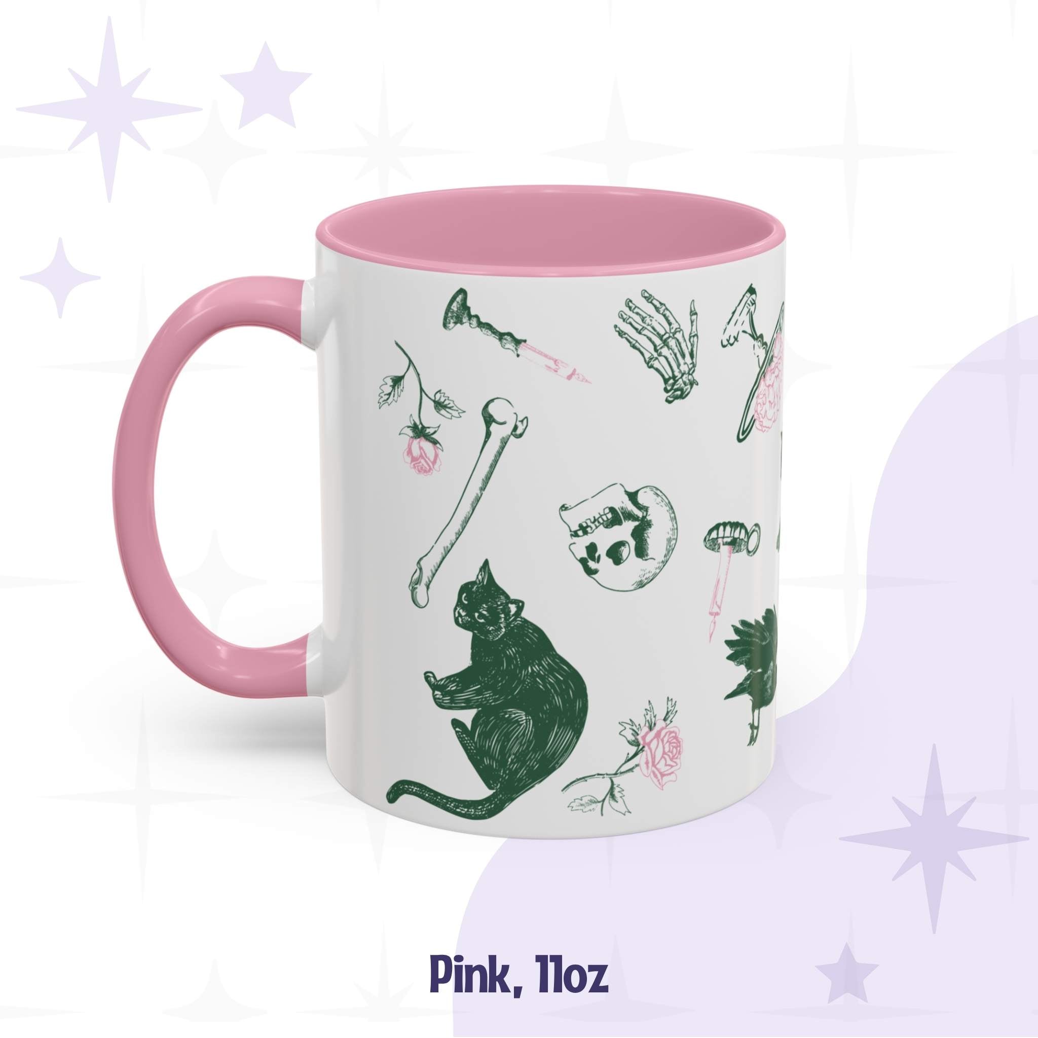 Pink 11oz preppy skull and bones mug, pink and green ditsy print with a black cat, loose bones, a skull, and a brain on a cake stand