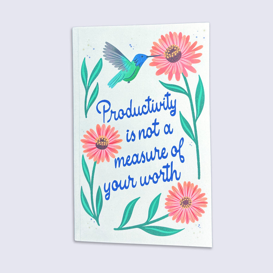journal with a hummingbird, flowers, and the quote &