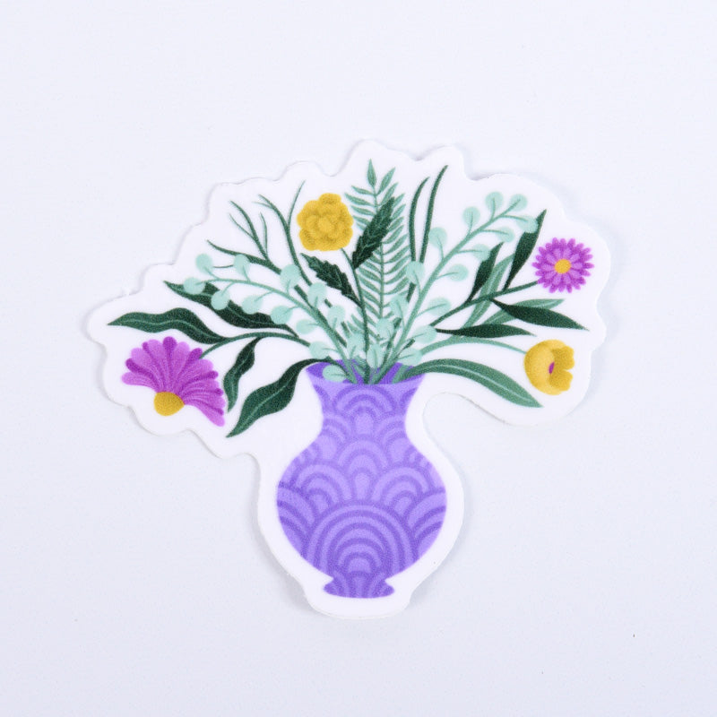 A sticker with a floral design featuring various colors like purple, green, and yellow, in a purple vase