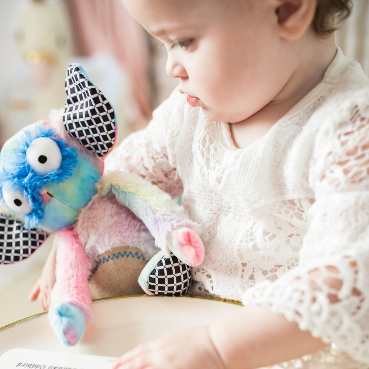 Rainbow Wobby Inklings Baby rainbow plush stuffed toy – LGBTQ inclusive pride baby gift with crinkle ears and belly rattle baby girl holding