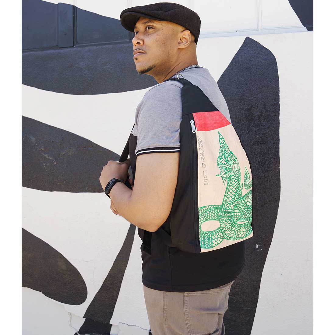 man wearing recycled backpack with cool serpent design