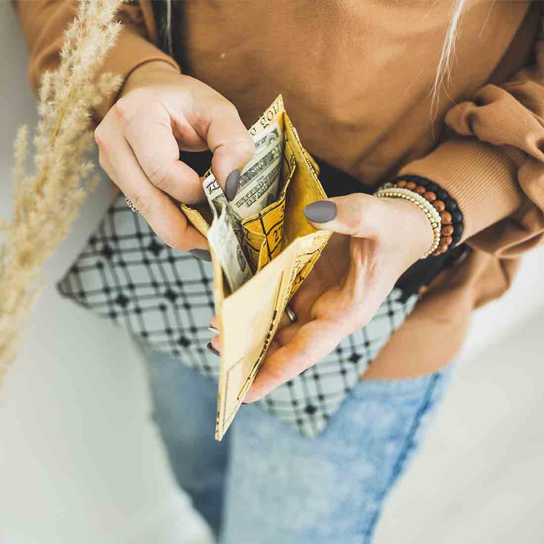 girl holding cheery yellow recycled wallet