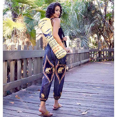 woman modeling yellow yoga mat bag made from recyled plastic