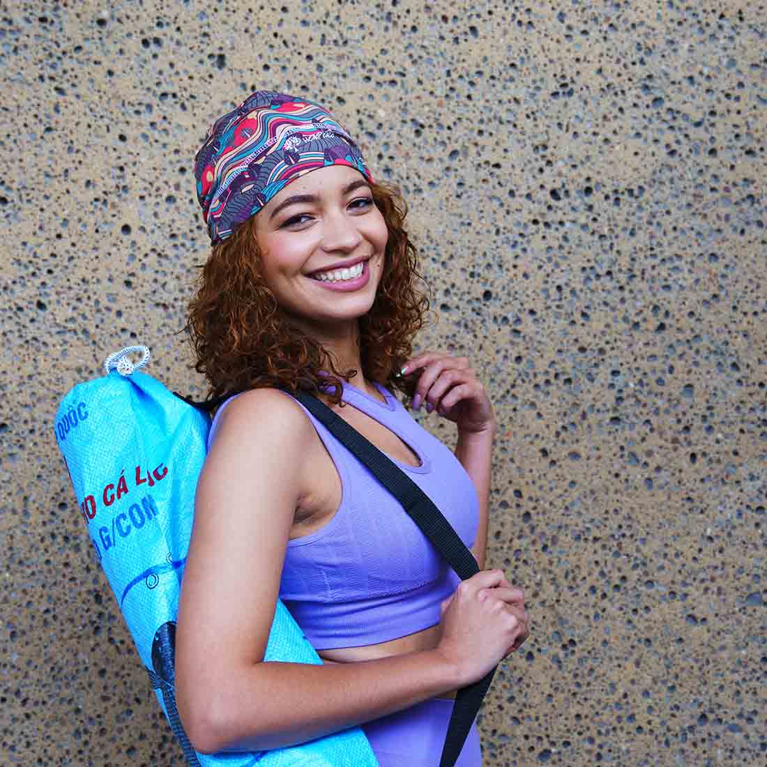 woman with blue recycled yoga mat bag