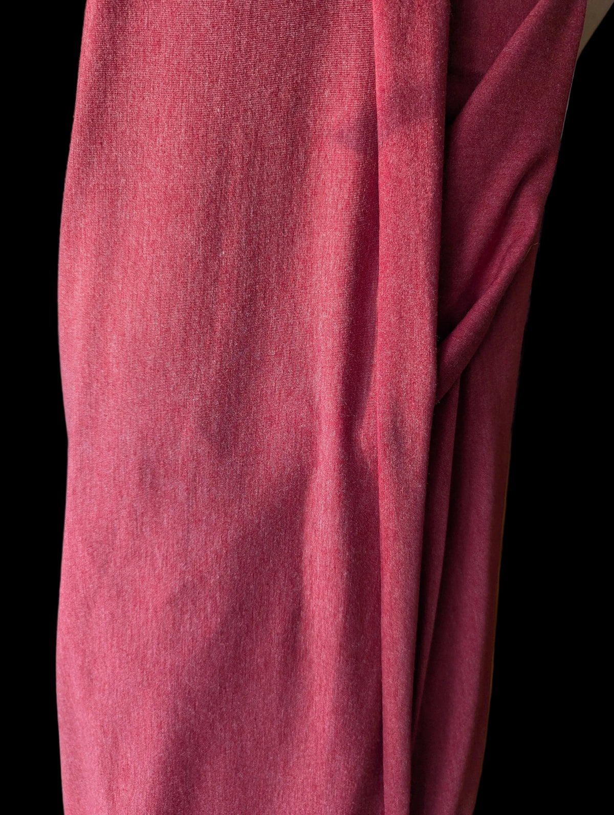 Vintage T-shirt weight cotton spandex in a red tomato color, draped off the bolt
