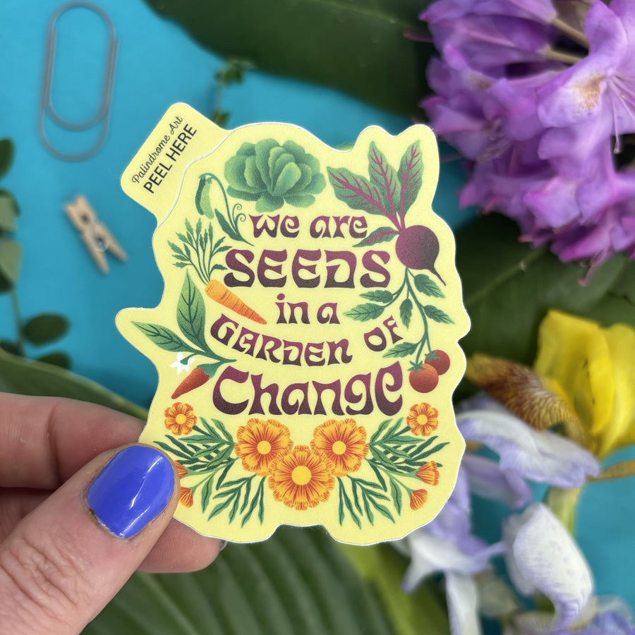 Hand holding a sticker with &