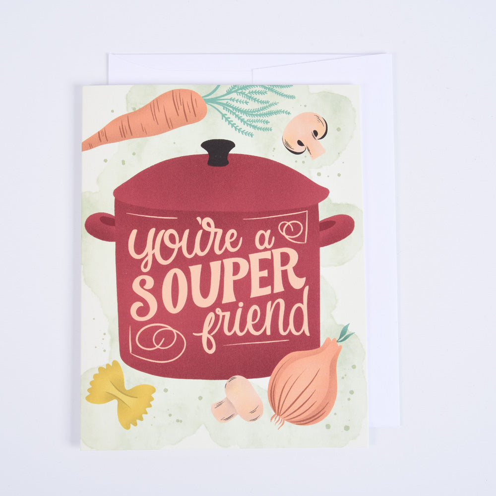 A folded greeting card with a red pot and vegetables on the front, with the text &