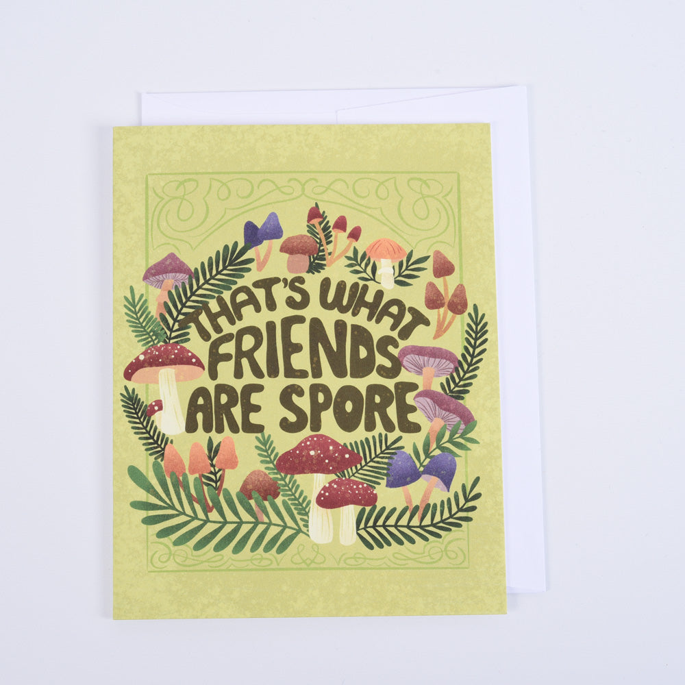 A folded greeting card with a colorful illustration of mushrooms and the text &