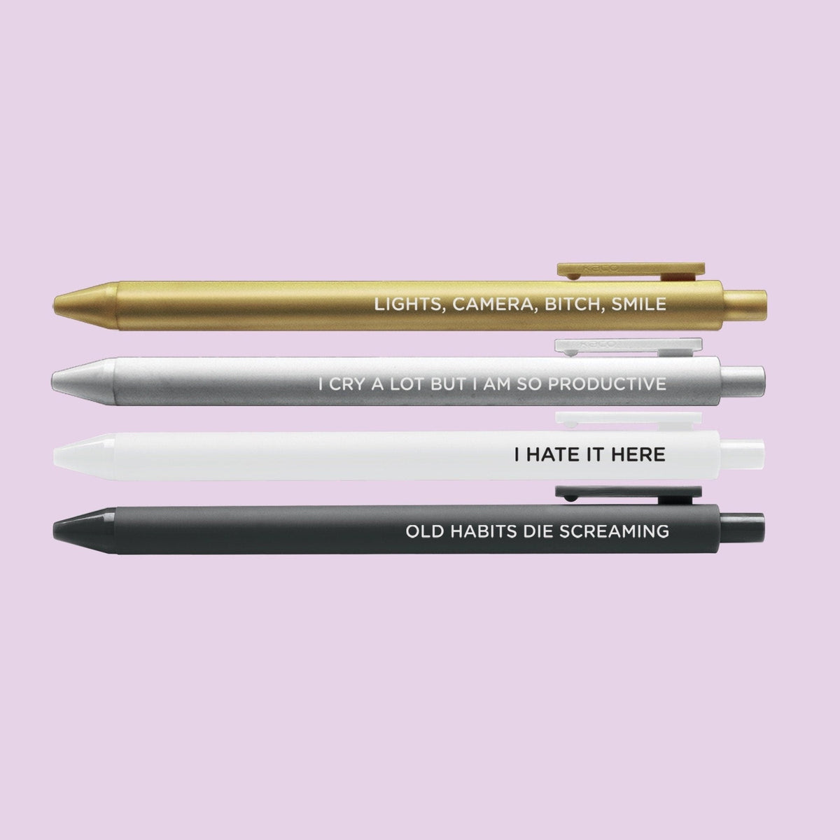 Tortured Poets Pen Set detail — gold and silver jotter pens with embossed lettering by indie artist MangoIllustrated