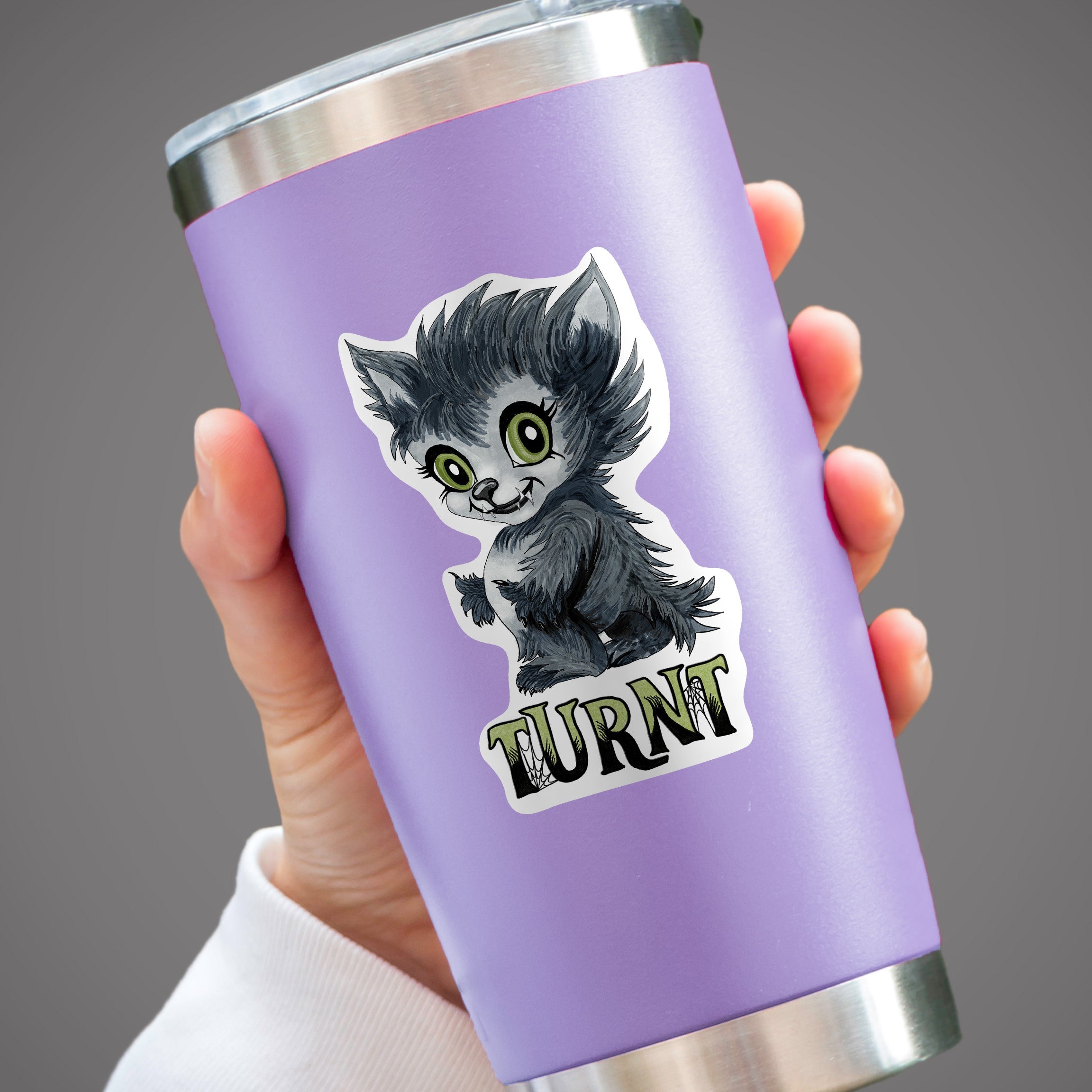 Turnt werewolf sticker on a lavender tumbler held in one hand